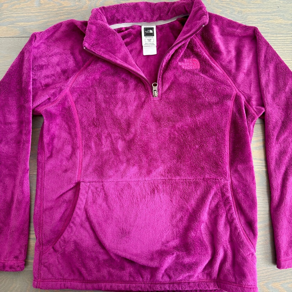 The North Face Magenta Girl’s Osito 1/4 Zip Pullover.